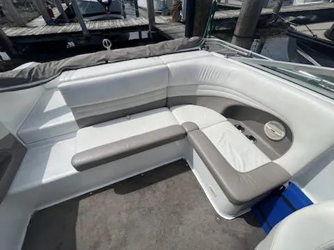 Slide: The Image of 1999 Cobalt 226 boat interior with white and gray seating, docked at marina. - 23