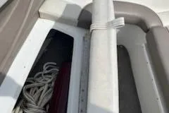 Slide: The Image of Interior view of a 1999 Cobalt 226 boat showing storage compartment with ropes. - 24