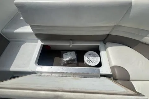 Slide: The Image of 1999 Cobalt 226 boat seat storage compartment with items inside. - 26