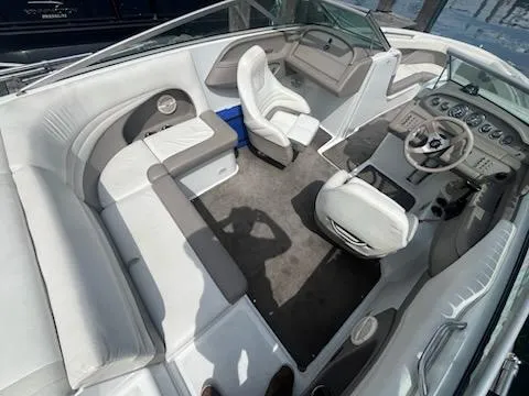 Slide: The Image of 1999 Cobalt 226 boat interior with white and gray seating, steering wheel, and dashboard. - 8