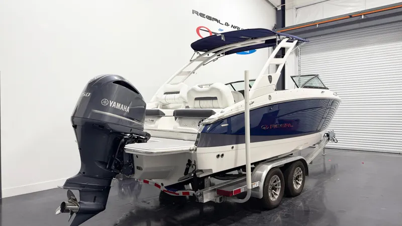 Slide: The Image of 2025 Regal LX4 boat with Yamaha outboard motor in showroom. - 3