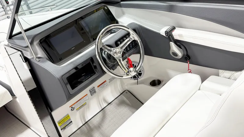 Slide: The Image of 2025 Regal LX4 boat cockpit with modern steering wheel and dual display screens. - 7