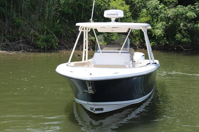 Slide: The Image of 2016 Pursuit S 280 Sport boat on calm water, surrounded by lush greenery. - 12