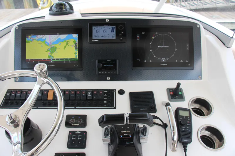 Slide: The Image of Control panel of a 2016 Pursuit S 280 Sport boat with Garmin navigation displays. - 13