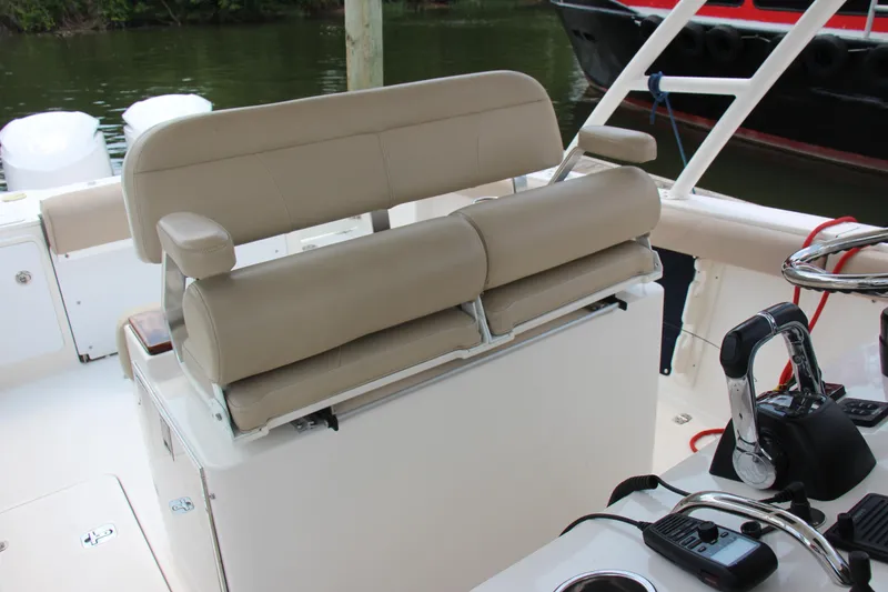 Slide: The Image of 2016 Pursuit S 280 Sport boat interior with beige seating and control panel. - 18
