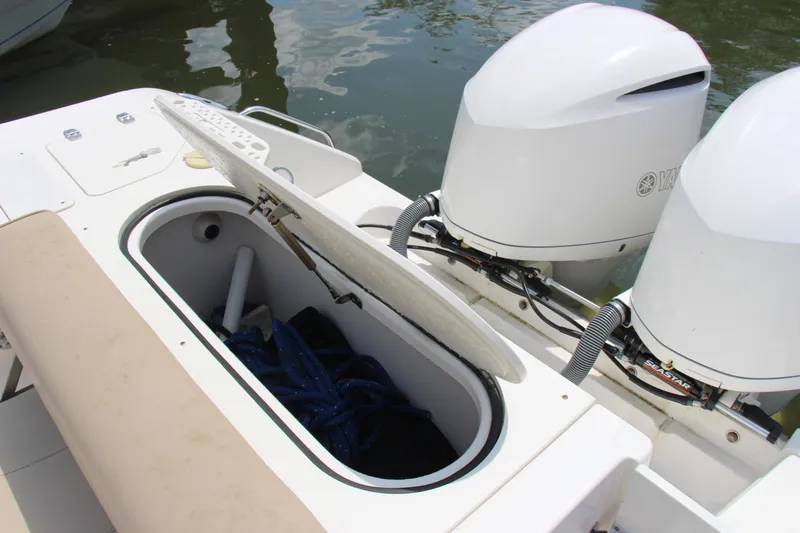 Slide: The Image of 2016 Pursuit S 280 Sport boat with open storage compartment and dual Yamaha outboard engines. - 21