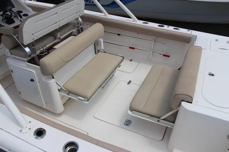 Slide: The Image of 2016 Pursuit S 280 Sport boat interior with beige seating and cup holders. - 22