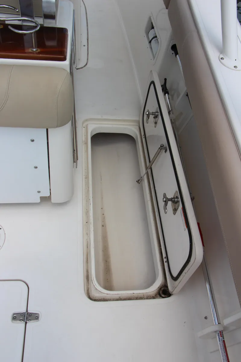 Slide: The Image of 2016 Pursuit S 280 Sport boat storage compartment with open hatch. - 24