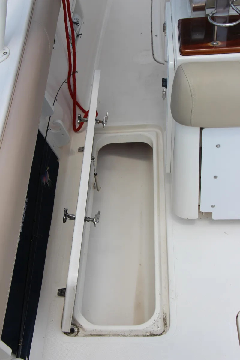 Slide: The Image of 2016 Pursuit S 280 Sport boat storage compartment with open hatch. - 25