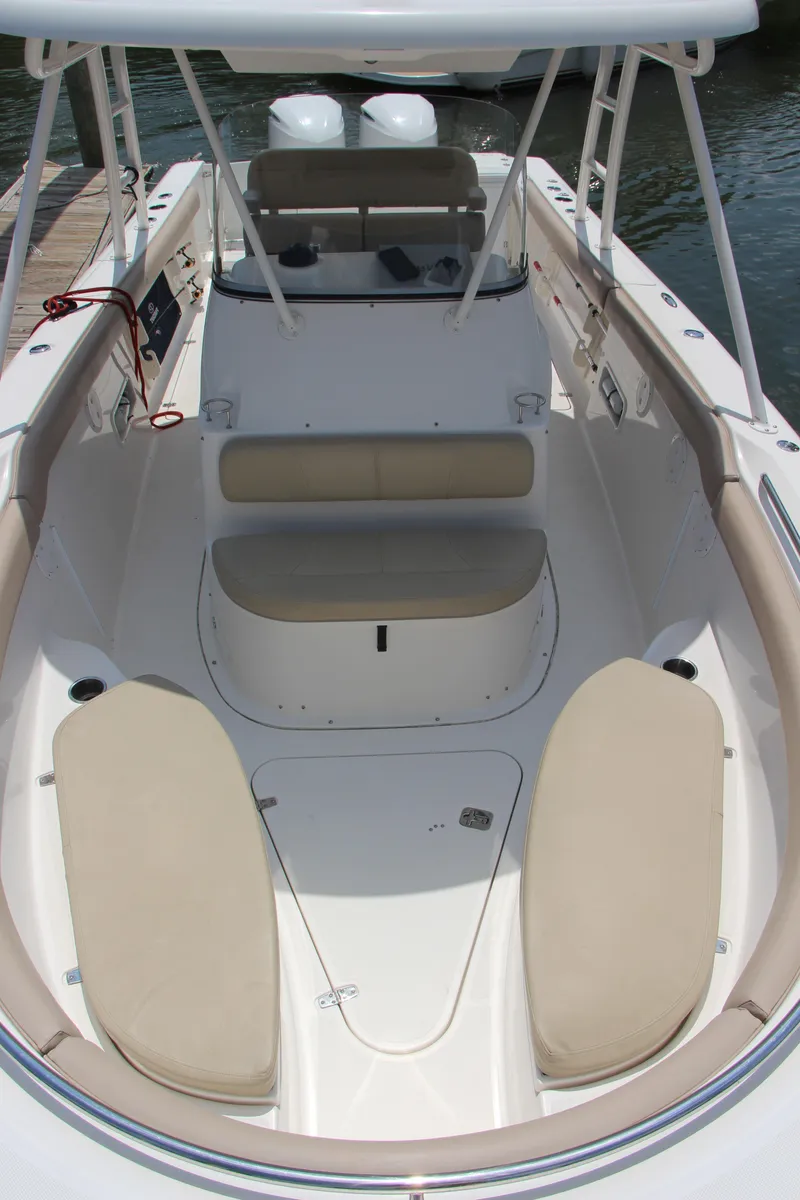 Slide: The Image of 2016 Pursuit S 280 Sport boat interior with beige seating and spacious layout. - 26