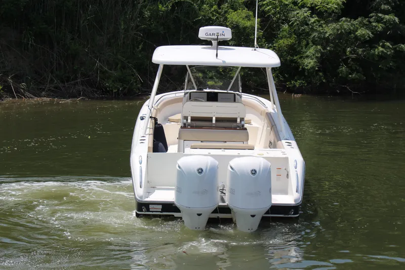 Slide: The Image of 2016 Pursuit S 280 Sport boat with dual engines on a calm river. - 5