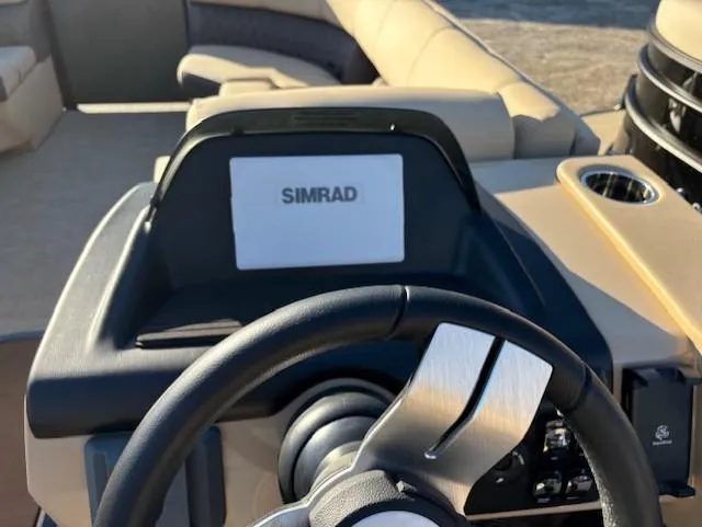 Slide: The Image of 2025 Harris Sunliner 230 dashboard with Simrad display and steering wheel. - 14