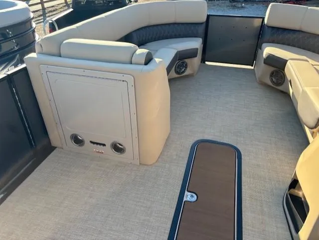 Slide: The Image of 2025 Harris Sunliner 230 boat interior with beige seating and carpeted floor. - 17