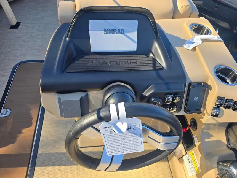 Slide: The Image of Steering console of 2025 Harris Sunliner 230 boat with Simrad display. - 18
