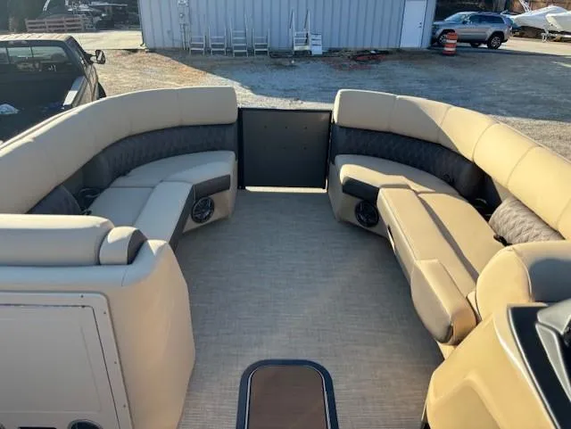 Slide: The Image of 2025 Harris Sunliner 230 boat interior with beige seating and spacious layout. - 9