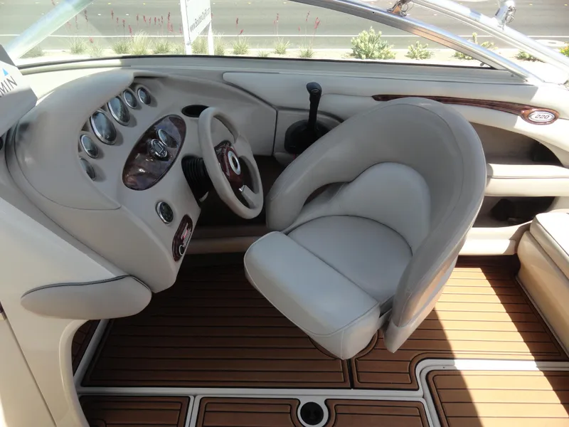 Slide: The Image of Interior of 2002 Sea Ray 220 Bow Rider boat with steering wheel and dashboard. - 10