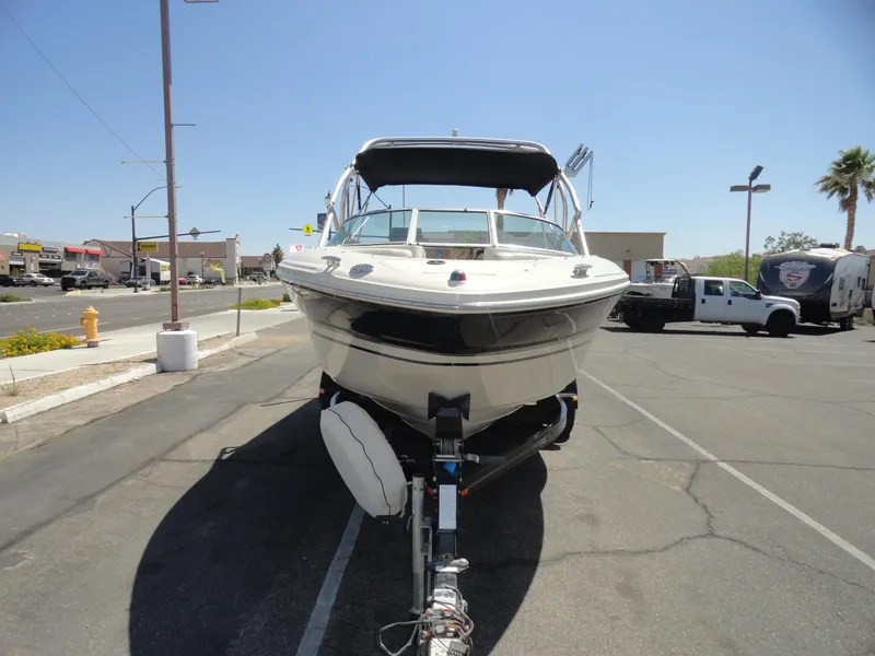 Slide: The Image of 2002 Sea Ray 220 Bow Rider boat on trailer in parking lot, sunny day. - 3