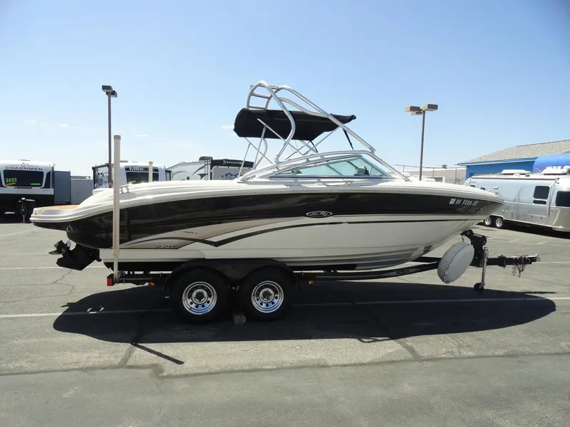 Slide: The Image of 2002 Sea Ray 220 Bow Rider boat on trailer in parking lot. - 5