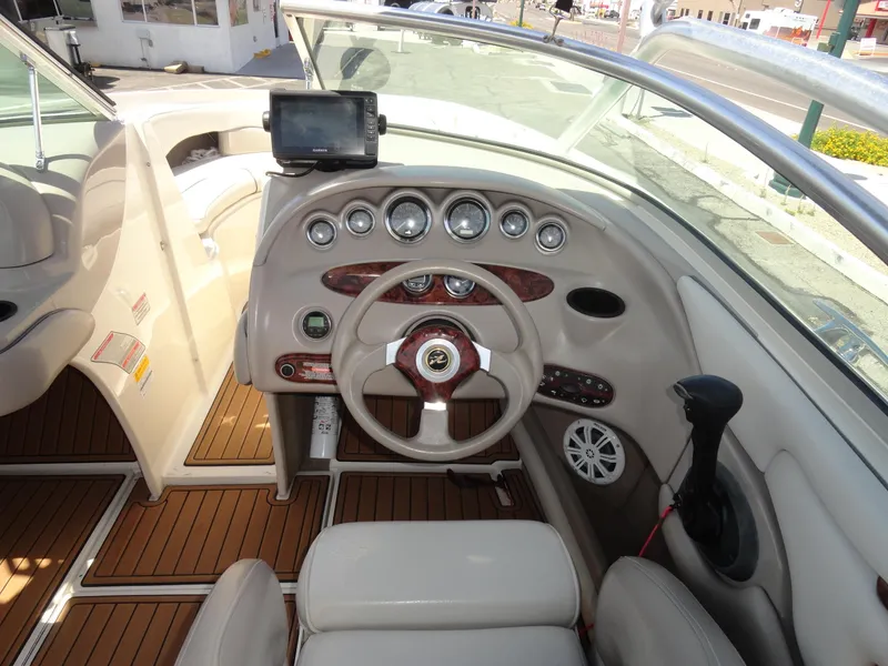Slide: The Image of 2002 Sea Ray 220 Bow Rider dashboard with steering wheel and navigation system. - 8