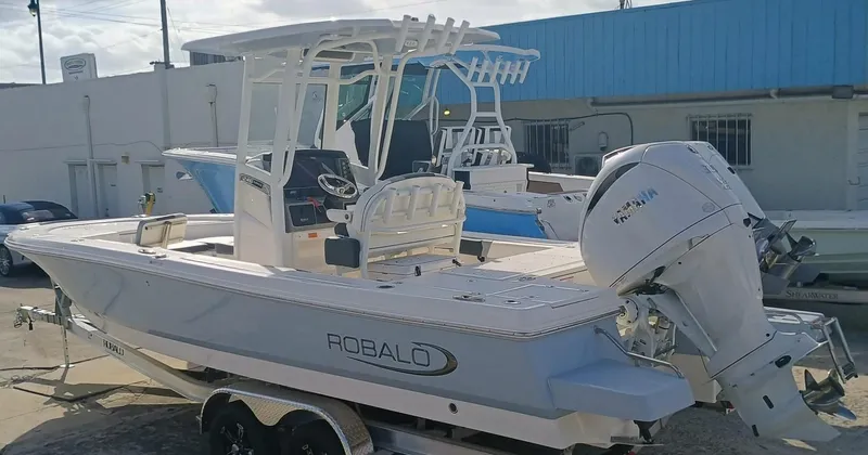 Slide: The Image of 2025 Robalo 246 Cayman boat with Yamaha outboard motor, parked on a trailer. - 3