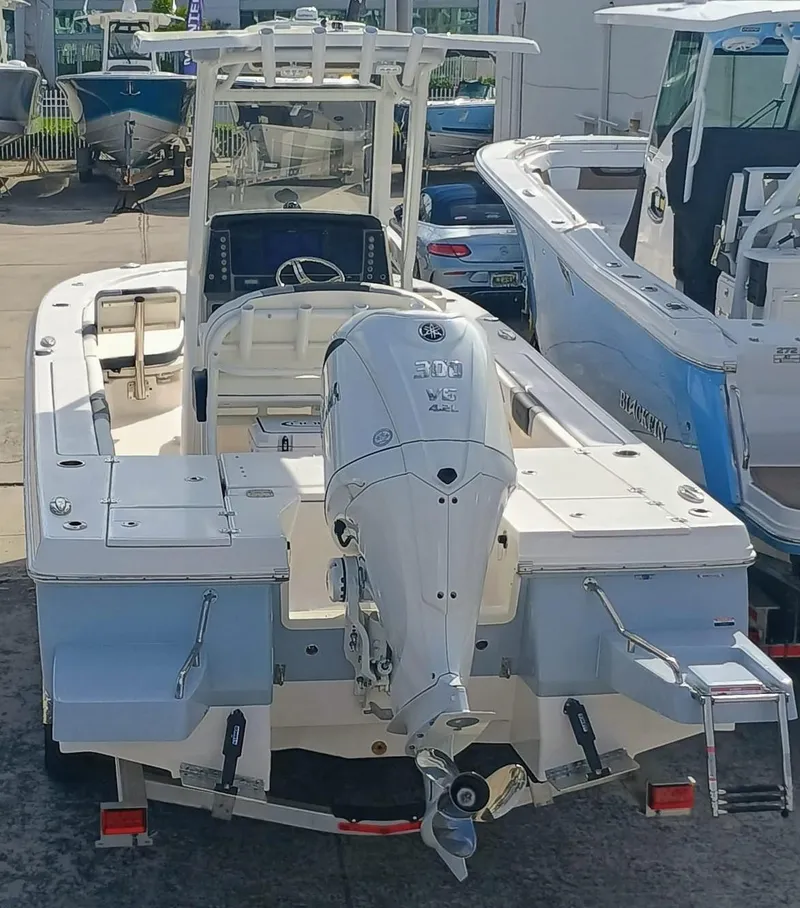 Slide: The Image of 2025 Robalo 246 Cayman boat with Yamaha 300 V6 engine, docked at marina. - 5