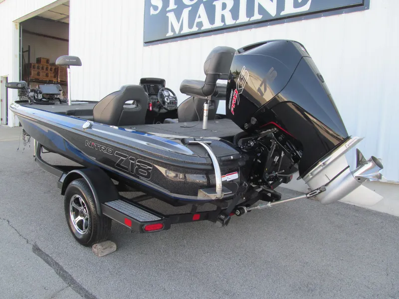 Slide: The Image of 2021 Nitro Z18 Pro boat with powerful outboard motor, parked outside a marine store. - 3