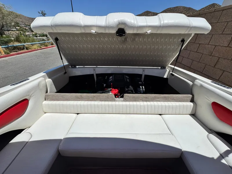 Slide: The Image of 2006 Stingray 195 LR boat interior with open engine compartment, white seating, and red accents. - 13