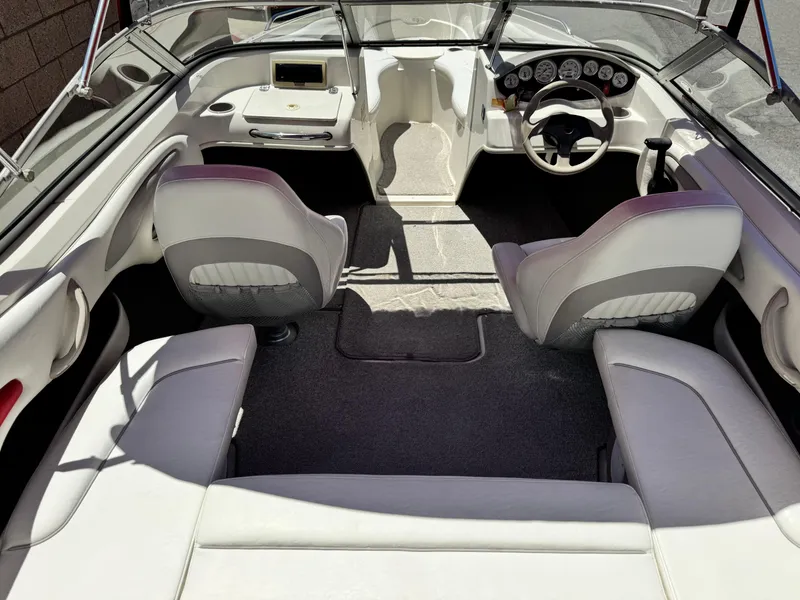 Slide: The Image of Interior of a 2006 Stingray 195 LR boat with seating and dashboard. - 15
