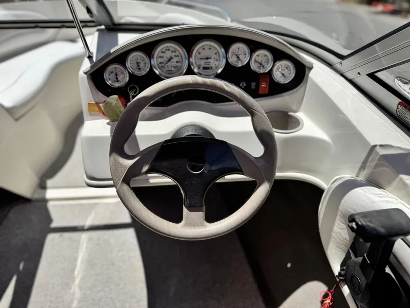 Slide: The Image of 2006 Stingray 195 LR boat dashboard with steering wheel and instrument panel. - 18