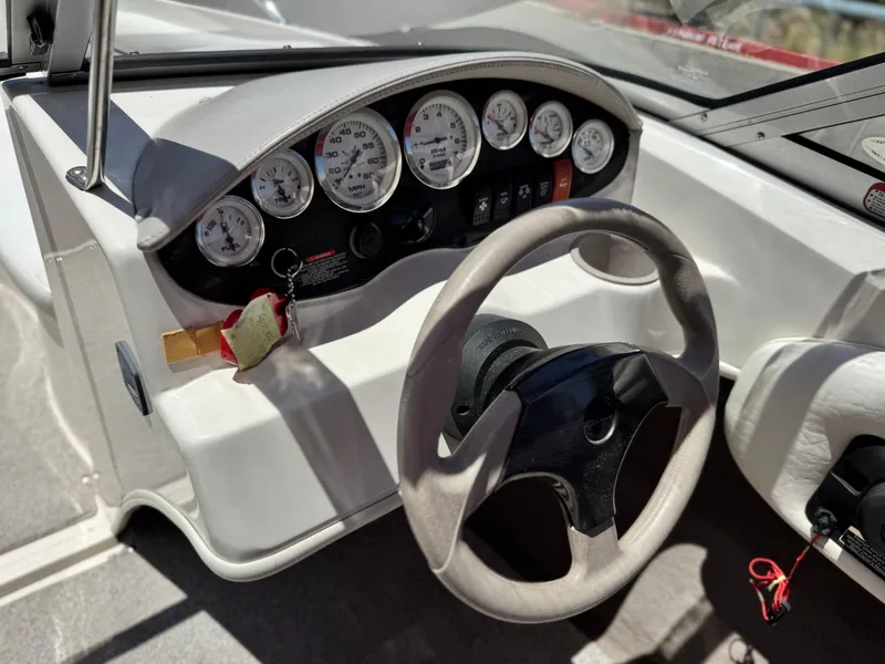 Slide: The Image of 2006 Stingray 195 LR boat dashboard with gauges and steering wheel. - 19