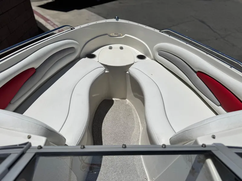 Slide: The Image of 2006 Stingray 195 LR boat interior with white and red seating, viewed from the bow. - 9