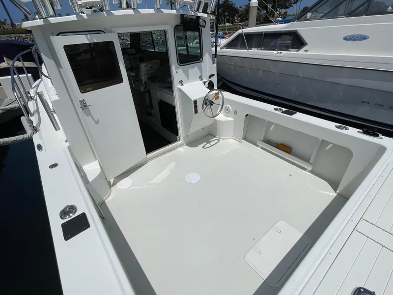 Slide: The Image of 2016 Parker 2530 Extended Sport Cabin boat with open deck and cabin entrance. - 14