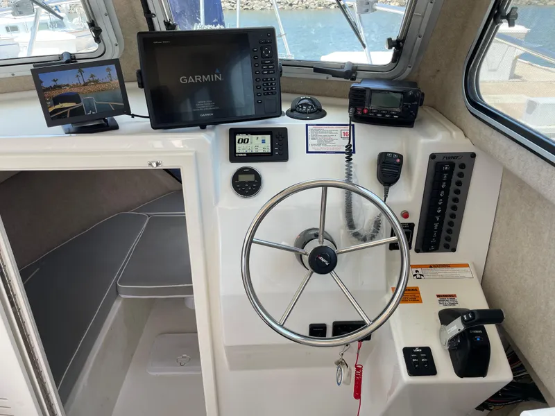 Slide: The Image of Interior of 2016 Parker 2530 Extended Sport Cabin with steering wheel and navigation equipment. - 29