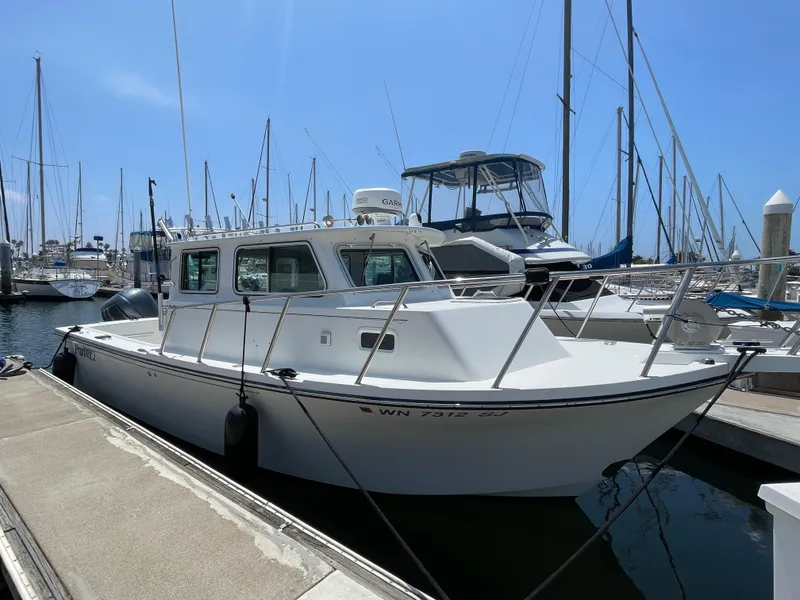 Slide: The Image of 2016 Parker 2530 Extended Sport Cabin boat docked at marina. - 3