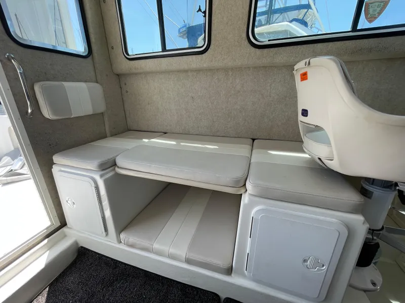 Slide: The Image of 2016 Parker 2530 Extended Sport Cabin interior seating with storage compartments. - 33
