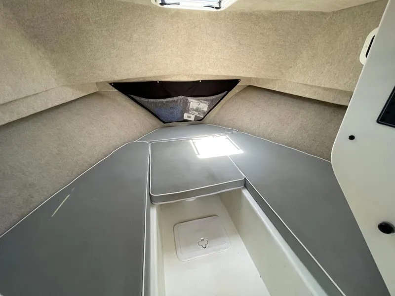 Slide: The Image of 2016 Parker 2530 Extended Sport Cabin interior with cushioned seating and storage compartment. - 36