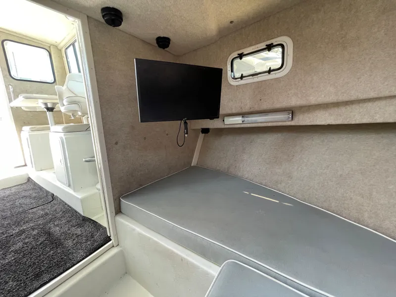 Slide: The Image of Interior of 2016 Parker 2530 Extended Sport Cabin with seating and mounted TV. - 38