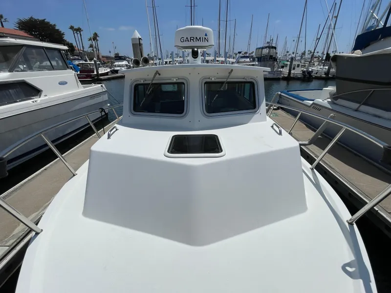 Slide: The Image of 2016 Parker 2530 Extended Sport Cabin boat docked in marina, featuring Garmin equipment. - 4