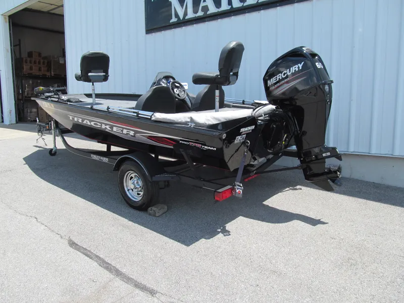 Slide: The Image of 2019 Tracker Pro Team 175 TXW boat with Mercury engine, parked outside a building. - 3