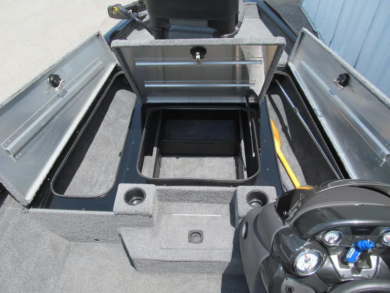 Slide: The Image of 2019 Tracker Pro Team 175 TXW boat interior with open storage compartments and dashboard. - 8