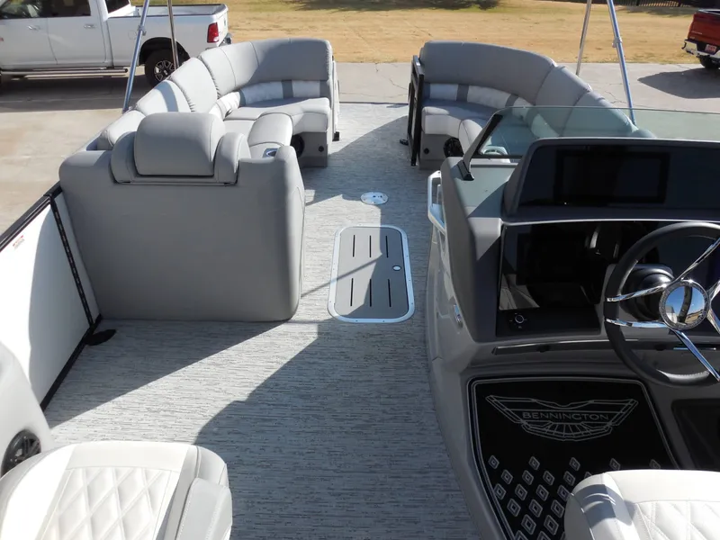 Slide: The Image of The image shows the interior of a 2025 Bennington 25 QFBA with luxurious gray seating. - 21