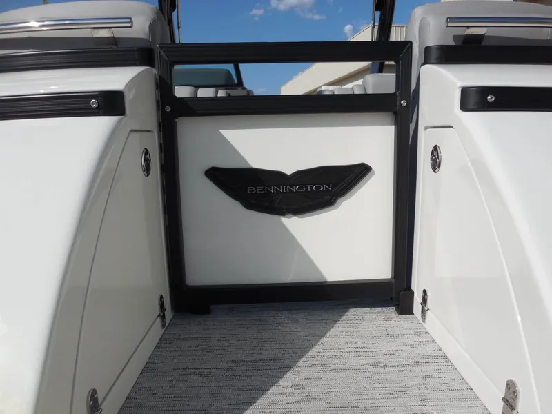 Slide: The Image of The image shows the entrance of a Bennington 25 QFBA boat with a stylish logo. - 14