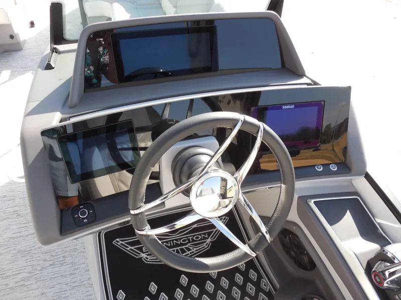 Slide: The Image of The image shows the helm of a Bennington 25 QFBA boat with modern instruments. - 19