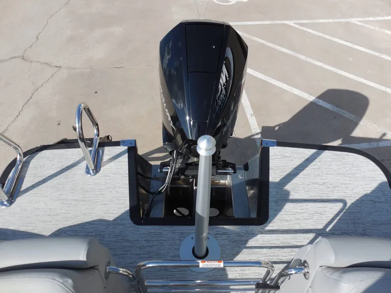 Slide: The Image of The image shows the stern of a Bennington 25 QFBA boat with an outboard motor. - 23