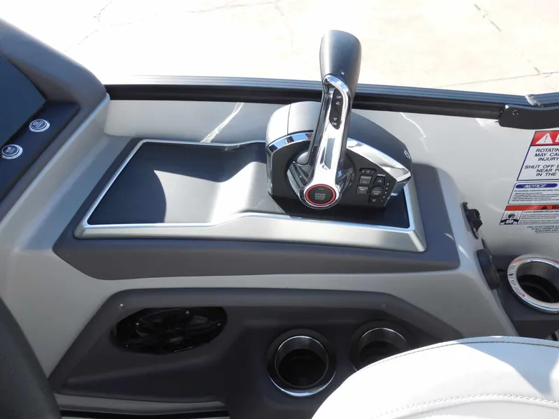 Slide: The Image of The image shows the helm console of a 2025 Bennington 25 QFBA with throttle and controls. - 20