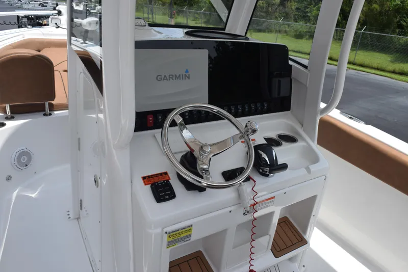 Slide: The Image of 2021 Sea Hunt Ultra 255 SE boat helm with Garmin display and steering wheel. - 10