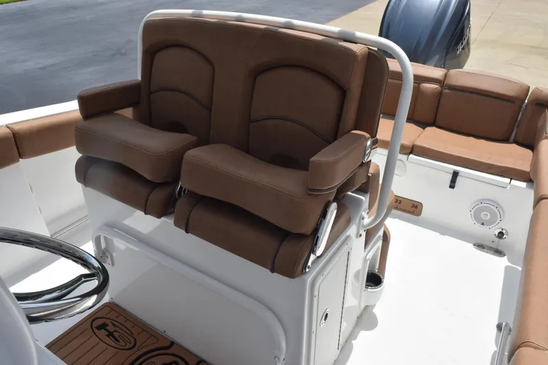 Slide: The Image of 2021 Sea Hunt Ultra 255 SE boat interior with brown cushioned seating. - 12