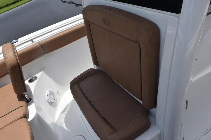 Slide: The Image of 2021 Sea Hunt Ultra 255 SE boat with brown cushioned seating. - 14