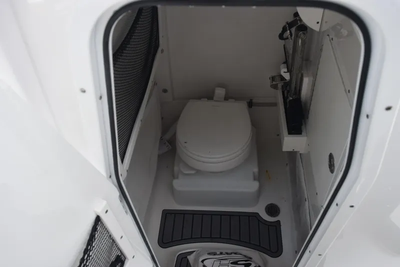 Slide: The Image of 2021 Sea Hunt Ultra 255 SE boat interior with compact marine toilet. - 15
