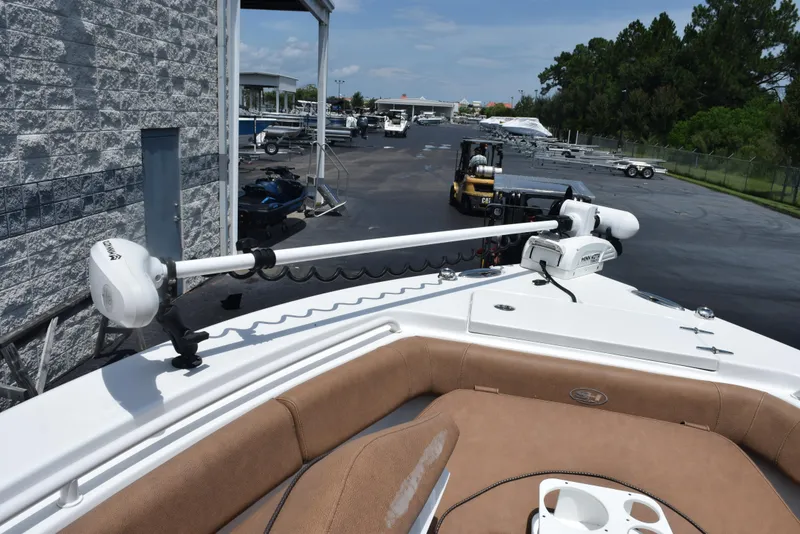 Slide: The Image of 2021 Sea Hunt Ultra 255 SE boat with trolling motor in a marina setting. - 17